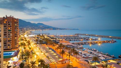 a city with a harbor and a marina at night at Casa Carolina - This One in Higuerón with Quality and Peace in Mijas