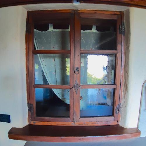 a wooden cabinet with a window on a wall at CleMaison Antica Dimora Apartments CIR VDA GIGNOD 0013 in Gignod