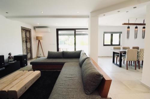 a living room with a couch and a table at Beautiful Algarve Pool Villa Bali 15min to beach in Mexilhoeira Grande
