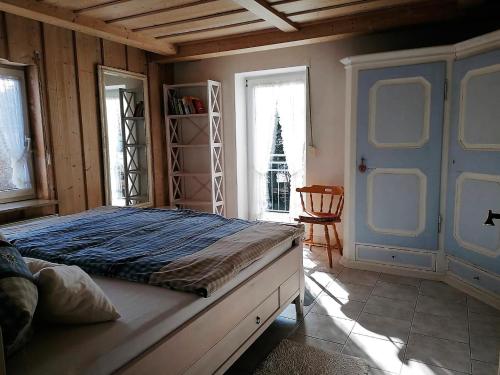 a bedroom with a large bed with a blue door at Ferienwohnung Ott Schongau in Schongau