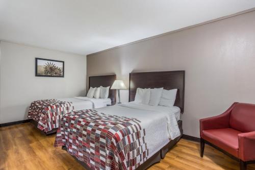 A bed or beds in a room at Red Roof Inn Meridian
