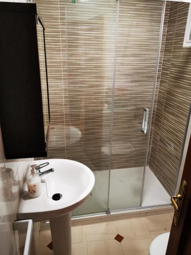 a bathroom with a sink and a shower at Duerming Portonovo Picó in Portonovo