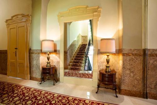 a hallway with a mirror and a staircase in a building at Hotel Villa Marie in Tremezzo