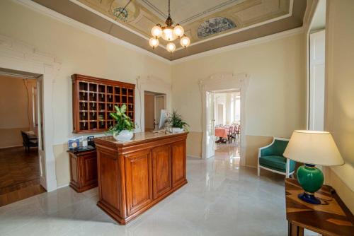 a large living room with a counter and a lamp at Hotel Villa Marie in Tremezzo