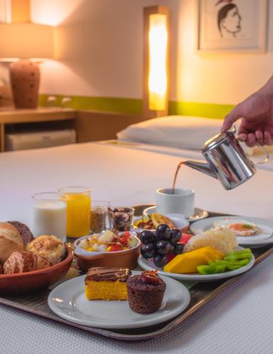 a tray of breakfast food on a table at Verdegreen Hotel in João Pessoa