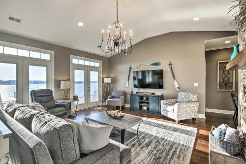 a living room with a couch and a tv at Elegant Lakefront Gem with Dock and Sunset Views! in Cross Hill