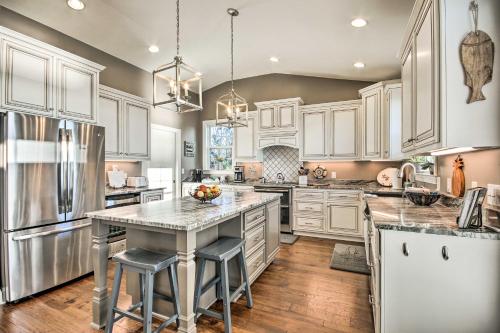 a kitchen with white cabinets and stainless steel appliances at Elegant Lakefront Gem with Dock and Sunset Views! in Cross Hill