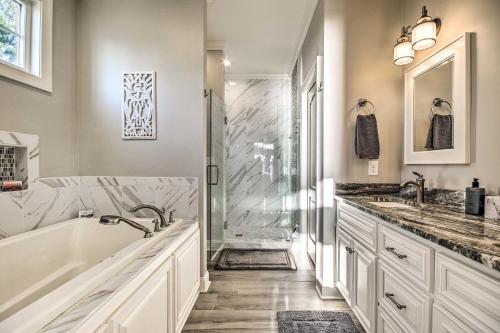 a bathroom with a tub and two sinks and a shower at Elegant Lakefront Gem with Dock and Sunset Views! in Cross Hill