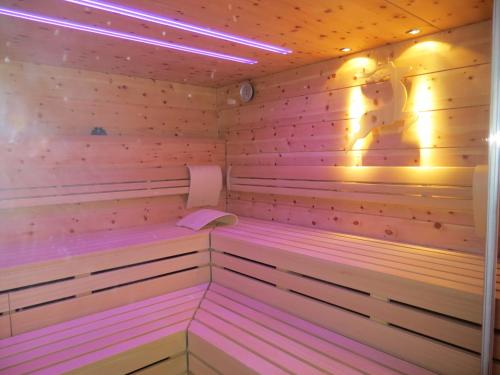 a sauna is shown with pink lighting at Hotel Hirschen in Glottertal