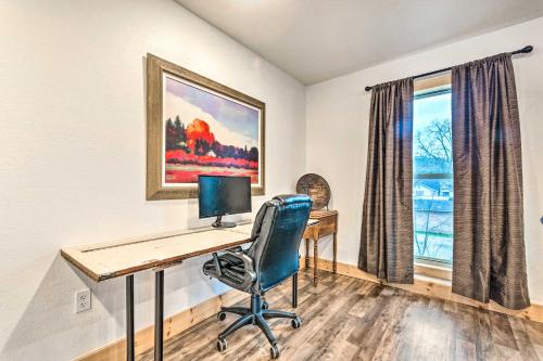 a desk with a computer in a room with a window at Spacious Apt Overlooking AR River Near Dtwn! in Russellville