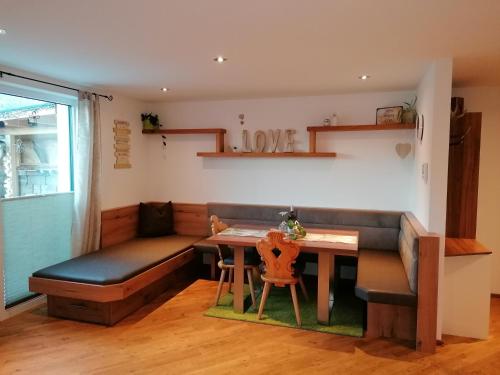 a dining room with a bench and a table at Apart Julia in Grins