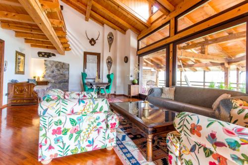 a living room with a couch and a table at Maso Azzurro Chalet in Stenico