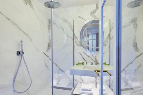 a bathroom with a shower and a sink at Holiday Inn Paris - Gare de Lyon Bastille, an IHG Hotel in Paris
