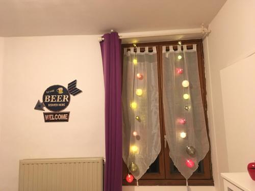 a room with a window with christmas lights at L auberge du lion d or in Nanteuil-sur-Marne