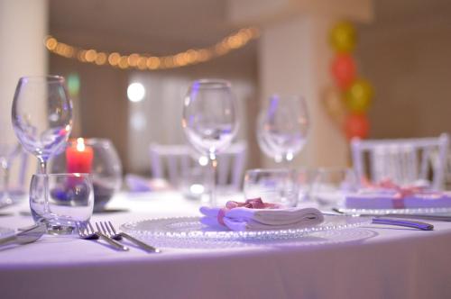 a table with wine glasses and a plate of food at International Resort in Mondragone