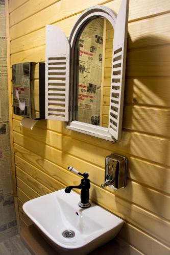 a sink in a bathroom with a mirror and a window at Villa Boro in Beli Iskar