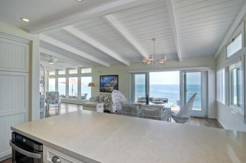 a kitchen with a dining room and a living room with the ocean at Oceanfront Villa with Private Beach Access, Remodeled Kitchen in Carlsbad