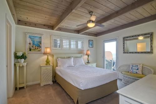 a bedroom with a bed and two lamps and a table at Oceanfront Villa with Private Beach Access, Remodeled Kitchen in Carlsbad