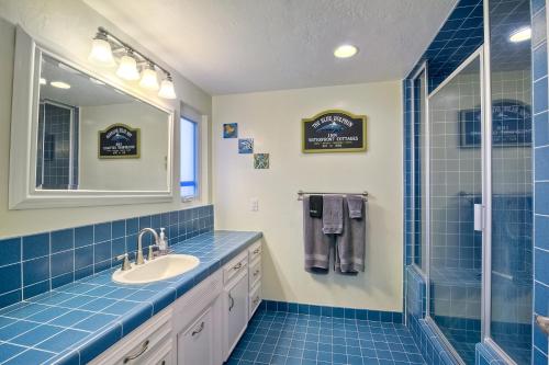 a blue tiled bathroom with a sink and a shower at Oceanfront Villa with Private Beach Access, Remodeled Kitchen in Carlsbad