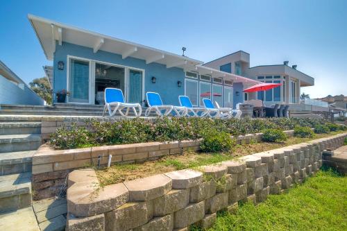 a house with blue chairs and a retaining wall at Oceanfront Villa with Private Beach Access, Remodeled Kitchen in Carlsbad