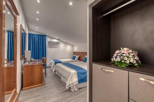 a hotel room with a bedroom with a bed at Swans Cay Hotel in Bocas del Toro