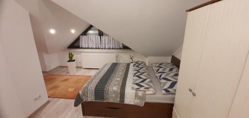 a small bedroom with a bed in a attic at Apartament Pod 12 A in Bielsko-Biała
