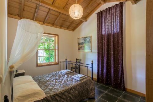 a bedroom with a bed and a window at Tapadinho Nature and Pool - Countryside Villa in Raiva