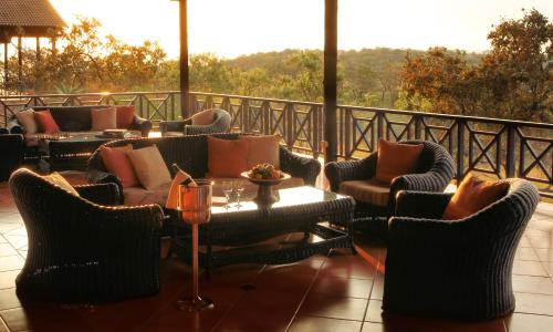 a patio with couches and a table and chairs at Pakamisa Private Game Reserve in Pongola