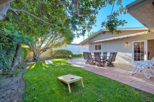 a patio with chairs and a table in a yard at Great Group Retreat! Hacienda Decor, Spacious Floor Plan, Private Backyard in Carlsbad