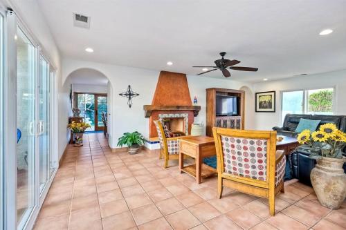 a living room with a table and a fireplace at Great Group Retreat! Hacienda Decor, Spacious Floor Plan, Private Backyard in Carlsbad