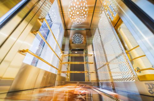 an escalator in a building with a person on it at Hotel Residence Plaza in Tbilisi City