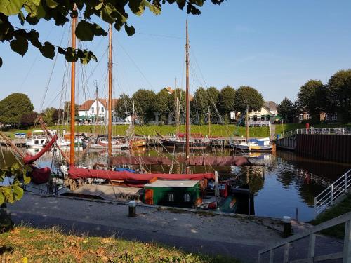 a group of boats docked in a marina at Smittshörn 3 - Oberdeck in Altfunnixsiel