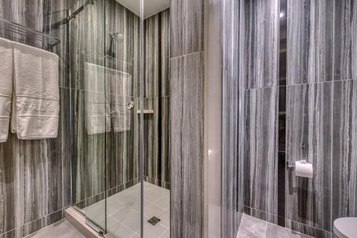 a bathroom with a shower with a glass door at Swans Cay Hotel in Bocas del Toro