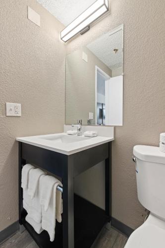 a bathroom with a sink and a mirror at Studio 6 Tucson, AZ - North in Tucson