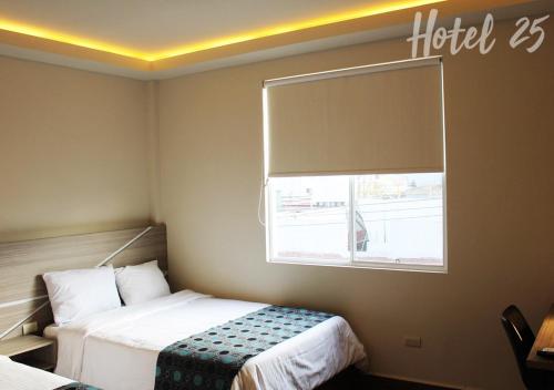 a hotel room with a bed and a window at Hotel25 in Monterrey