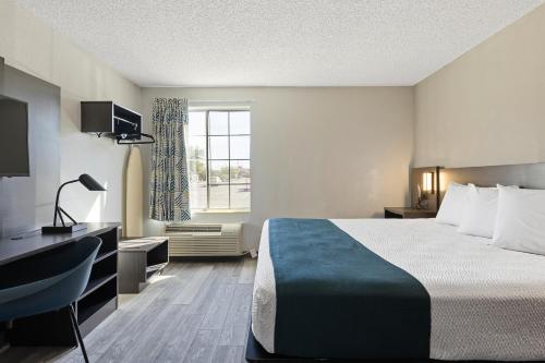 a hotel room with a bed and a window at Studio 6 Tucson, AZ - North in Tucson