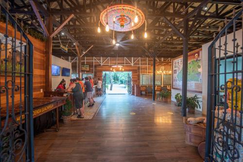 a hallway of a restaurant with people standing at the counter at Hacienda Guachipelin Volcano Ranch Hotel & Hot Springs in Liberia