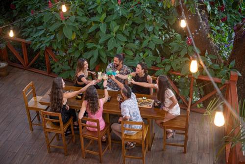 a group of people sitting around a wooden table at Hacienda Guachipelin Volcano Ranch Hotel & Hot Springs in Liberia