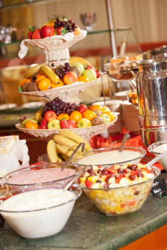 a bunch of baskets of fruit on a counter at Hotel Latini in Zell am See
