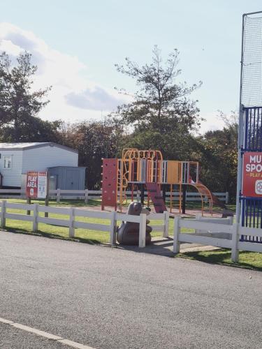 a playground on the side of a road at Palm grove in Chapel Saint Leonards