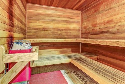 a small sauna with wooden walls and wooden shelves at Honeycomb House in Solitude