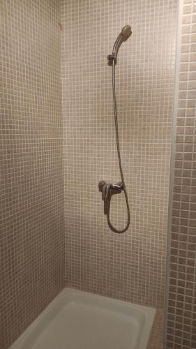 a shower in a tiled bathroom with a tub at Casa Babuche in Algar