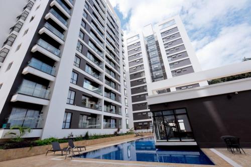 an apartment complex with a swimming pool in front of two tall buildings at Astoria apartments in Nairobi