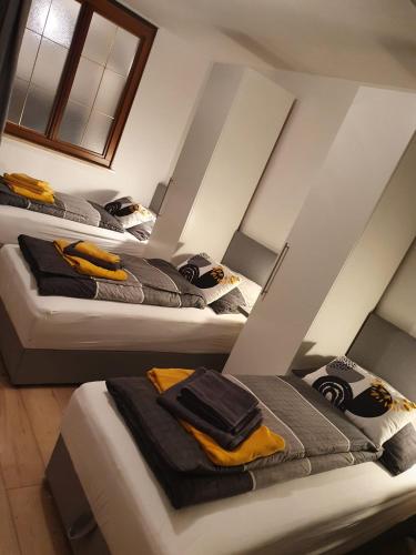 a group of three beds in a room at Leon2 in Linz
