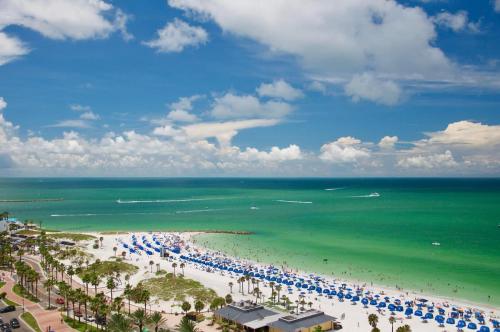 an aerial view of a beach with umbrellas and the ocean at Beach condo in the heart of Clearwater beach in Clearwater Beach