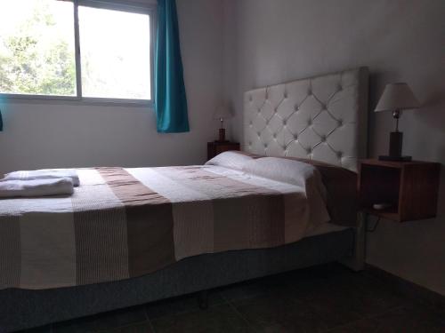 a bedroom with a large bed with a window at Campo de los Zorros in Nono