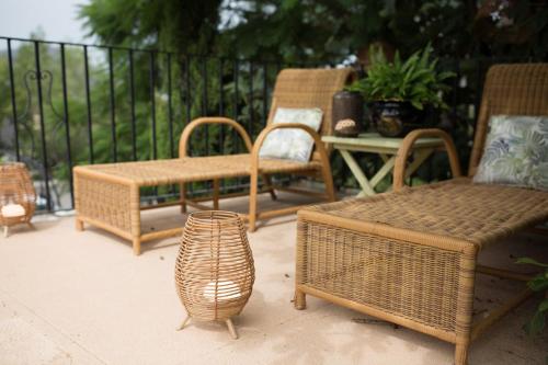a group of wicker chairs and a table on a patio at El Cid Country Club in Benidoleig
