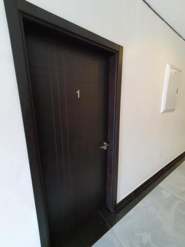 a black door in a room with a white wall at The Turk Boutique Hotel in Durban