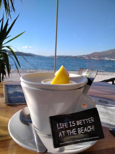 a cup of coffee with a sign that says life is better at the beach at Luxury Apartment Dreams in Okrug with swimming pool, sea view, Wifi, parking in Trogir