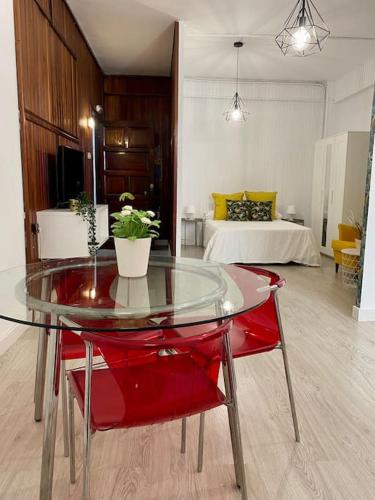 a glass table in a room with a bedroom at Edificio Rambla Pulido in Santa Cruz de Tenerife